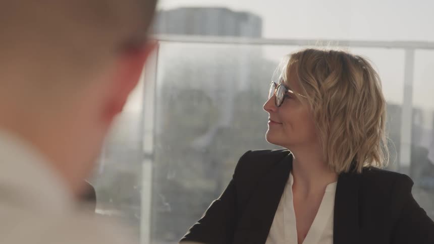 Business people sitting at a table conduct a meeting in the conference room
