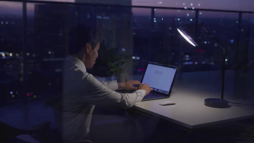 A man is working in his office at night