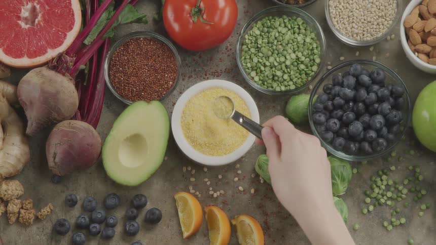 A person measuring healthy food with a measuring spoon