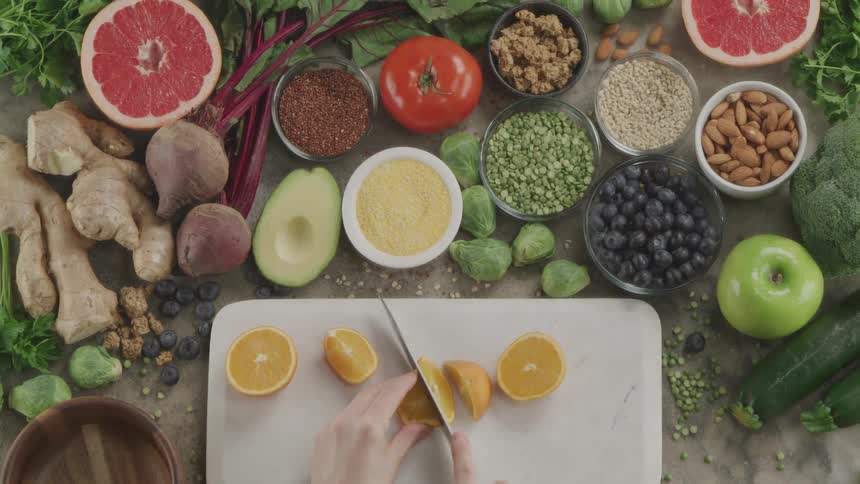 A woman cutting an orange