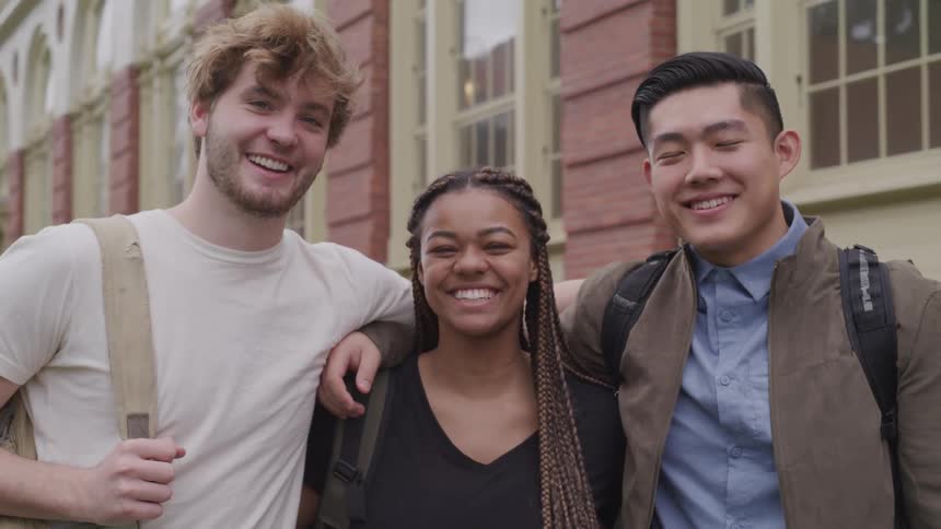 A group of friends are standing outdoors together