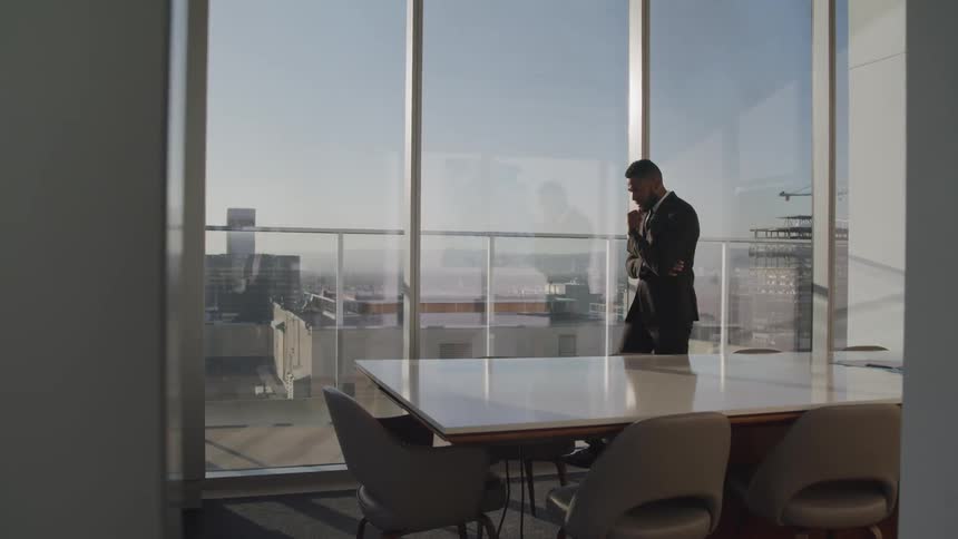 A man is pacing in an office building