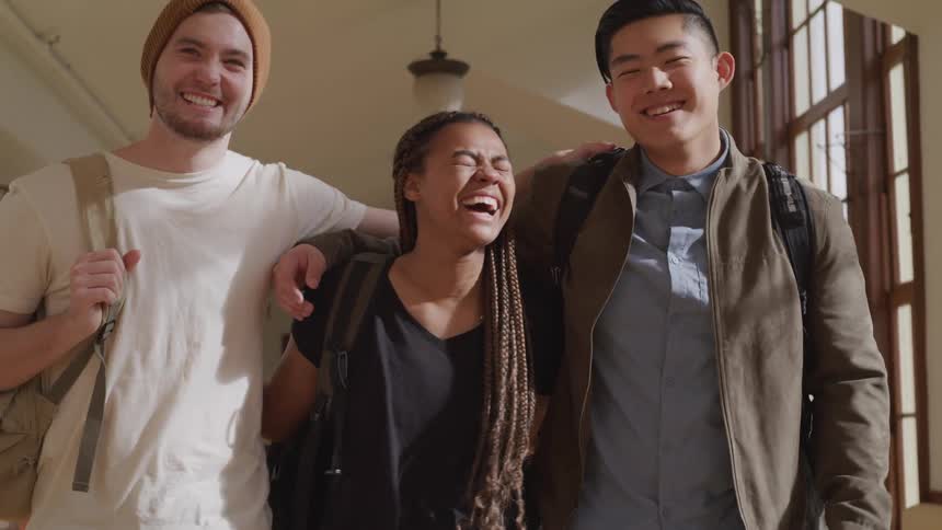Three friends are walking in a building together