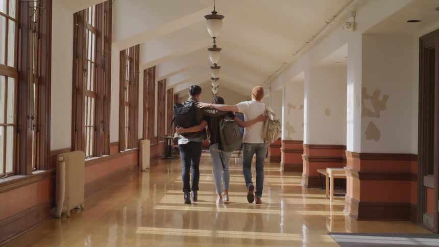 A group of friends are walking through a building together