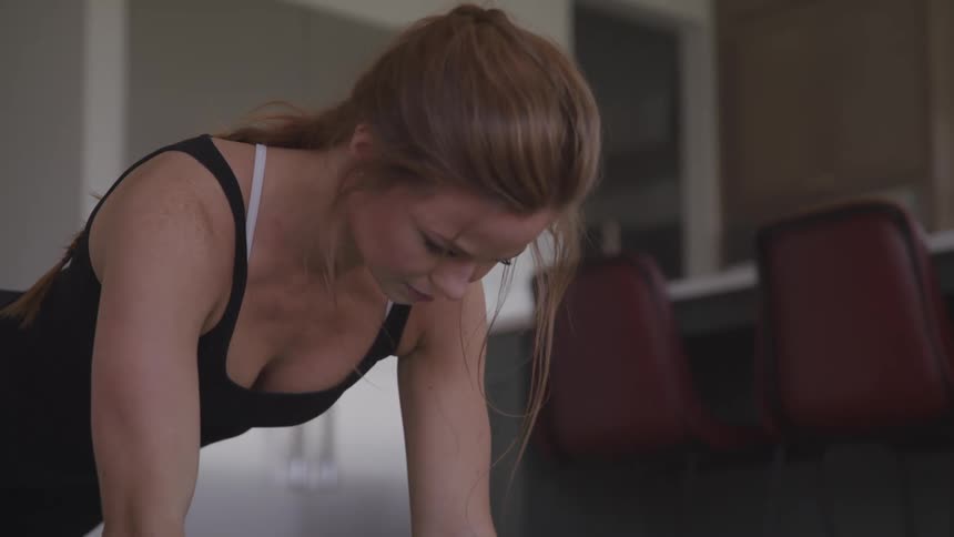 A woman is exercising indoors