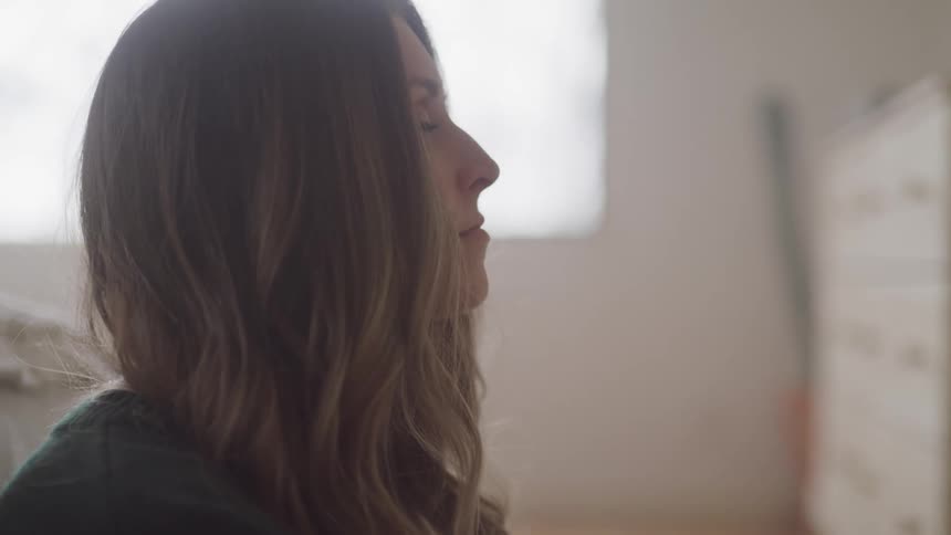 A woman looks up in the bedroom