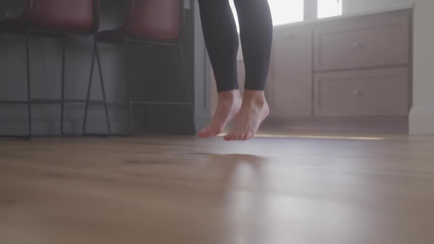 A woman jumping rope at home