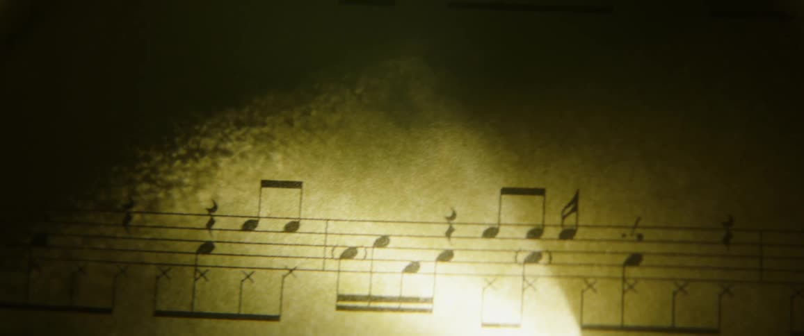 A light shines on a music sheet