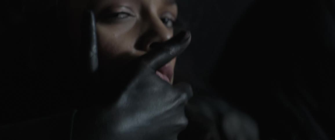 Hands grab and pull on a woman's face