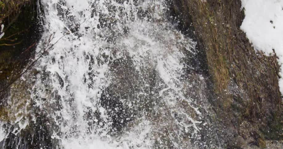 The waterfall is pouring from the cliff