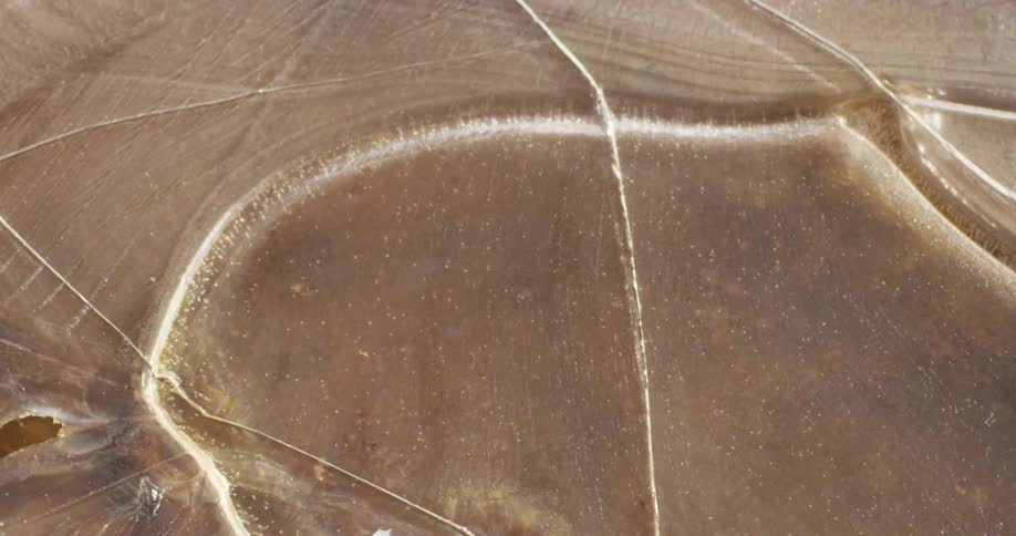 Ice cracking on a puddle