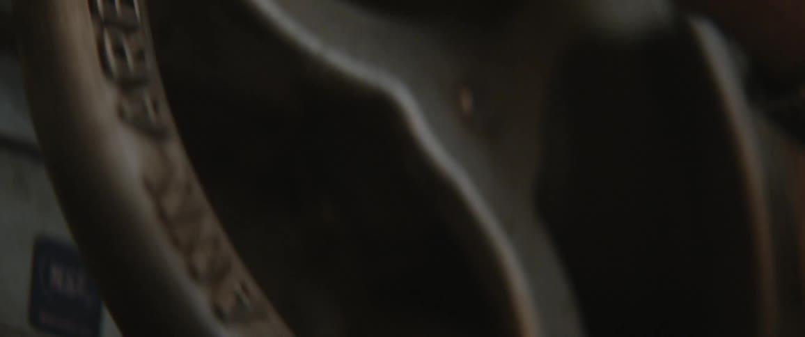 A man turns a wheel on a piece of equipment