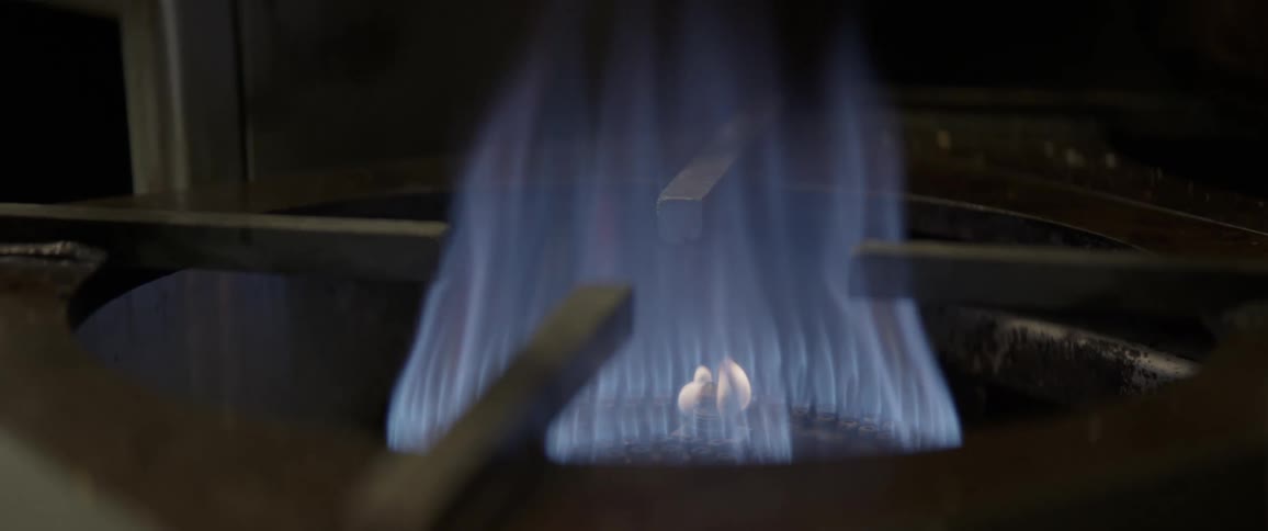 A stove top burner is turned on