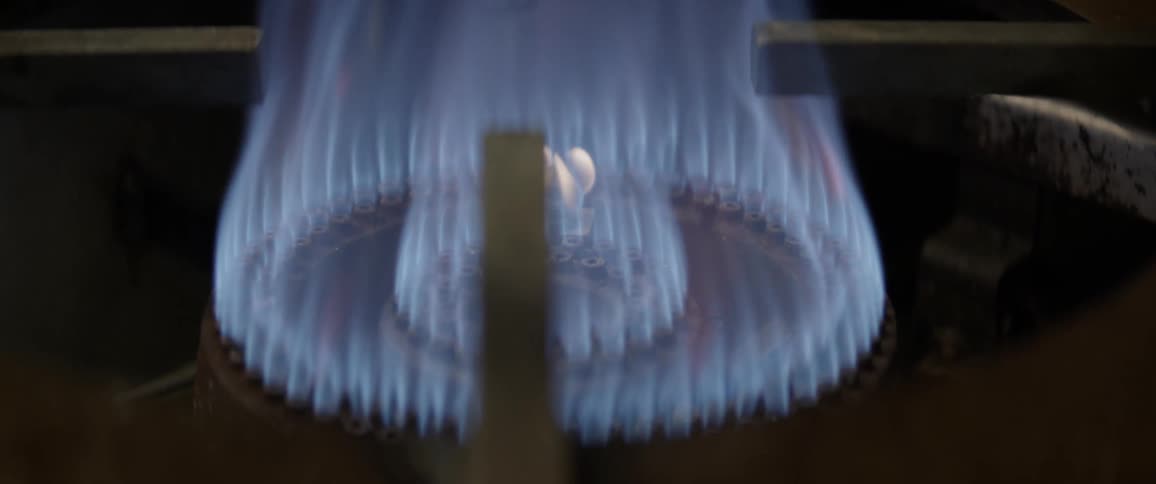 A stove top burner is turned on