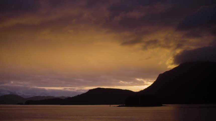 Clouds slowly move above the coast at dusk