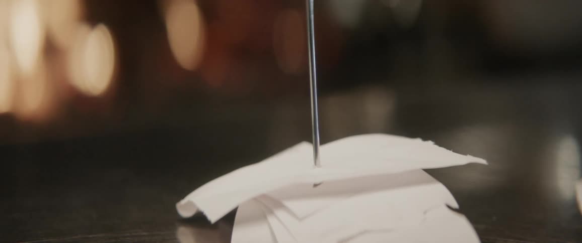 Receipts are stacked into a metal stake