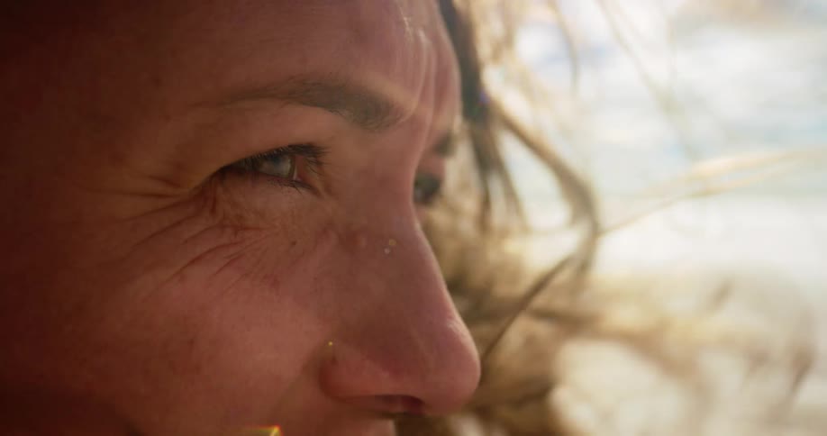 Closeup of woman's eyes staring intently into a vast desert