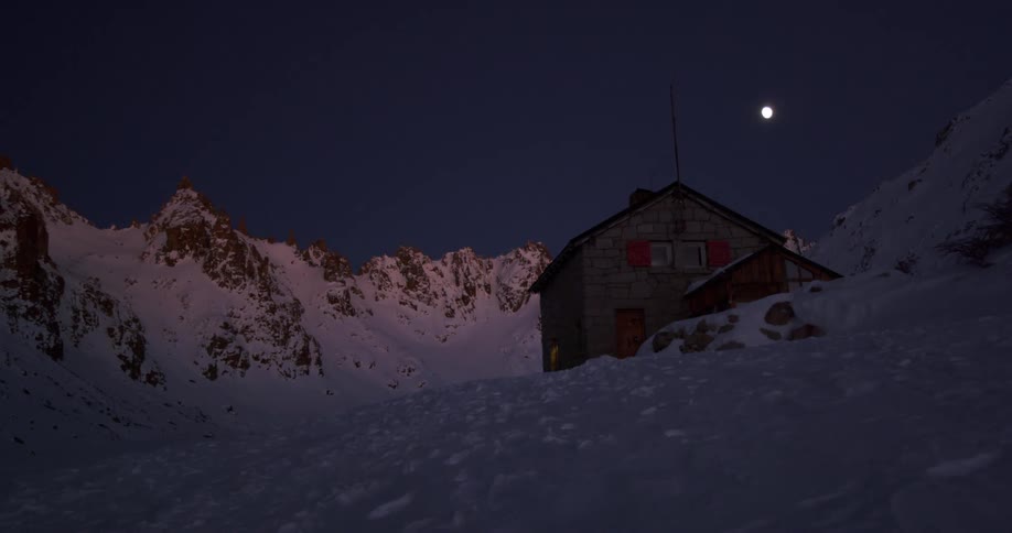 The moon is high above the house on the mountain