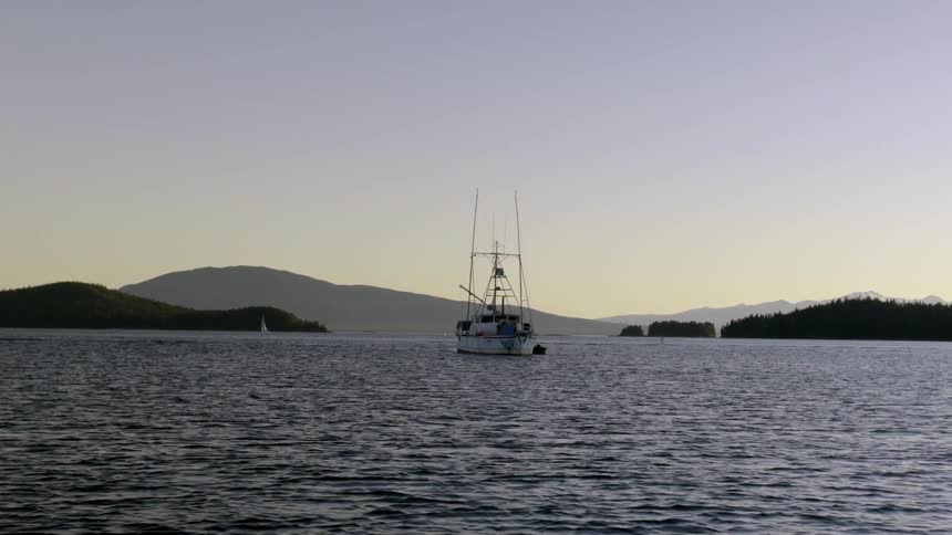 A fishing boat sitting anchored in a harbor