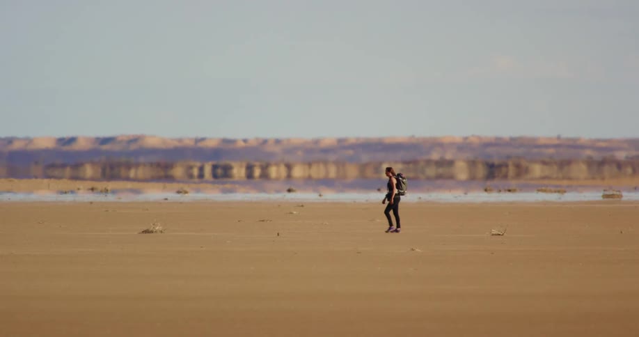 A person hikes across endless desert