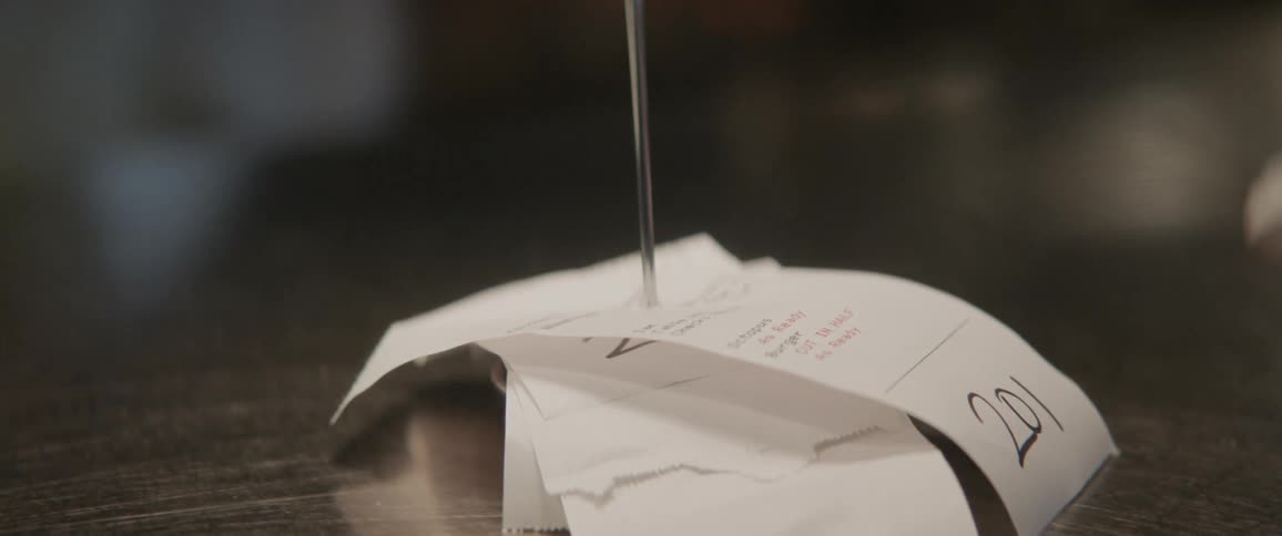 Receipts are stacked into a metal stake
