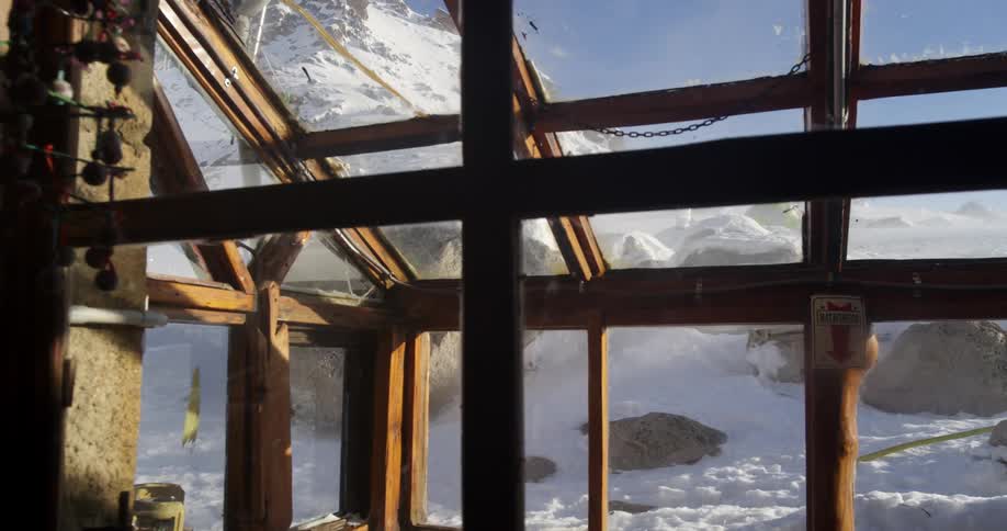 Interior of a mountain shelter on the snow covered peaks of a mountain range at morning