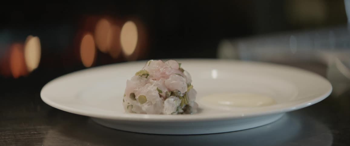 A mound of food sits on a white plate