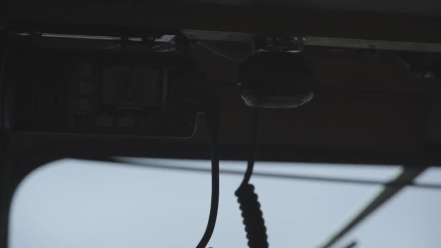 A cb hanging in the cab of a truck