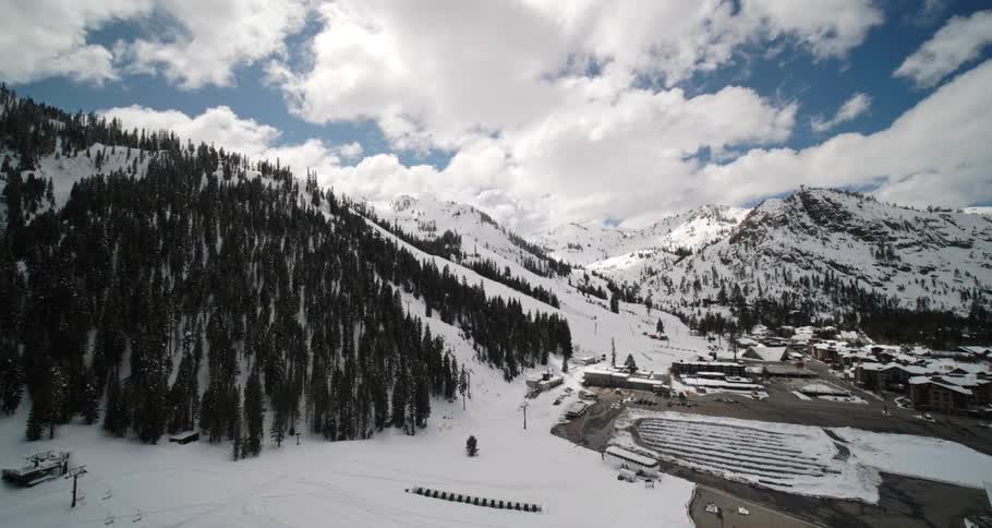 The mountains are covered with trees and snow