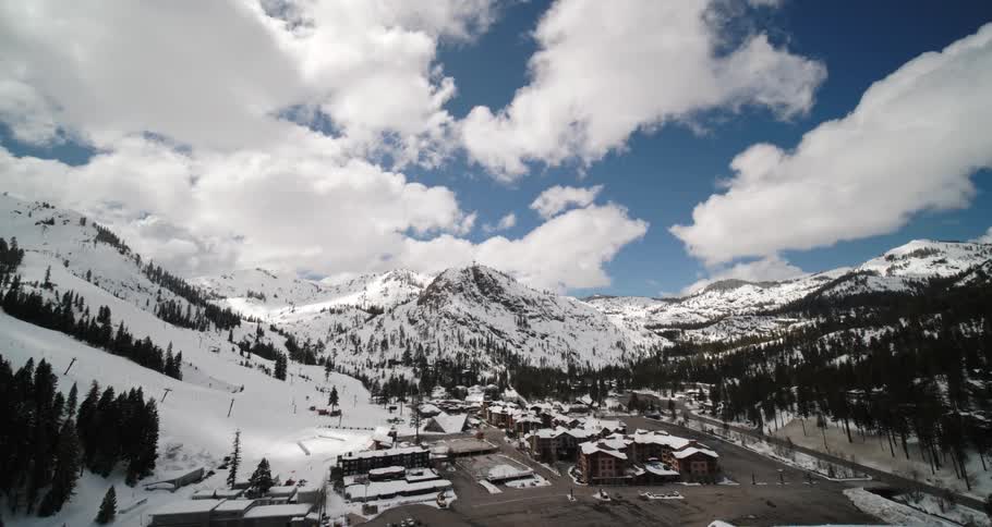 Aerial view of buildings at the base of a snow covered mountain