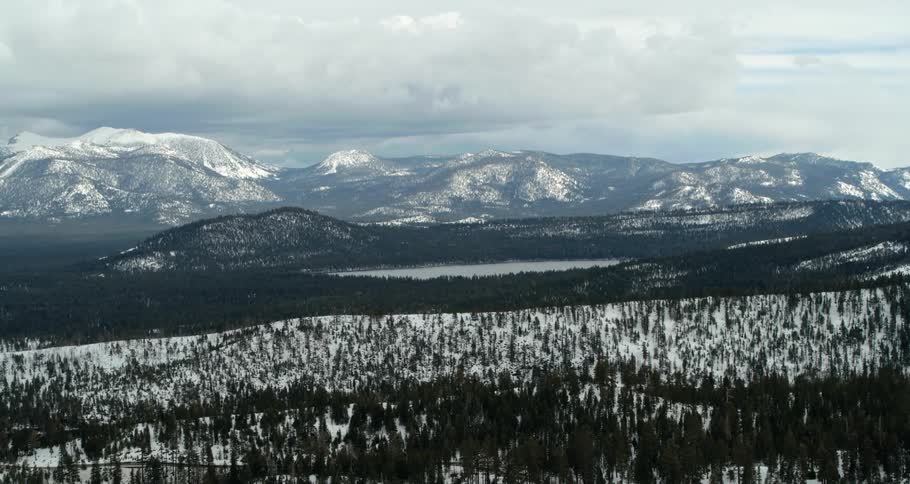 The forest covers the hills before the mountain