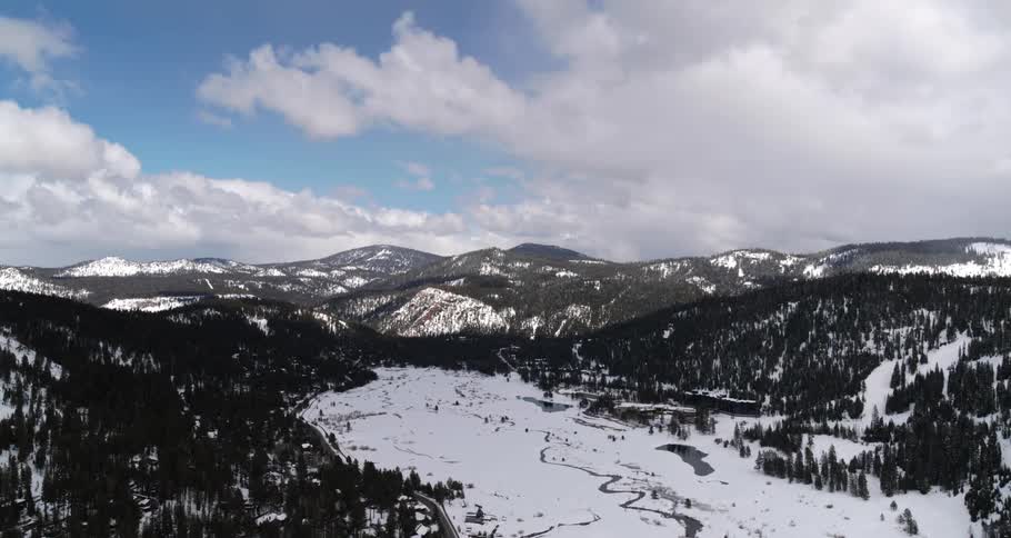 From high above a snow covered mountainous landscape can be seen below