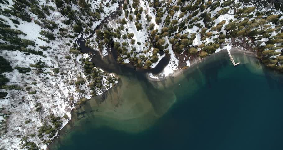 An aerial view of a lake and the coast and a forest