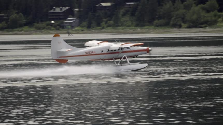 A small airplane floats on a lake