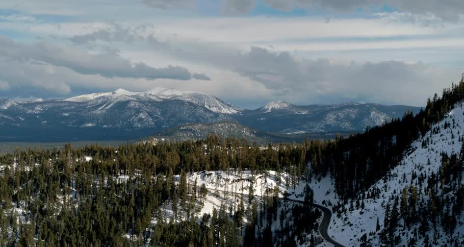 An aerial view of a forest and mountain range