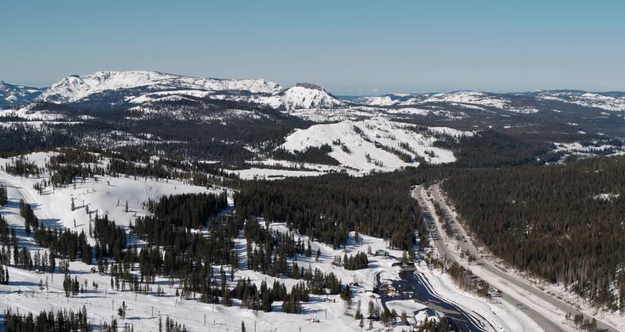 An aerial view of snowy mountains on a winter day