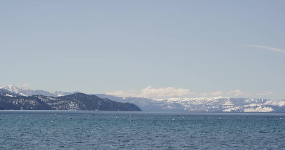 View of sea with snow capped mountains in the background