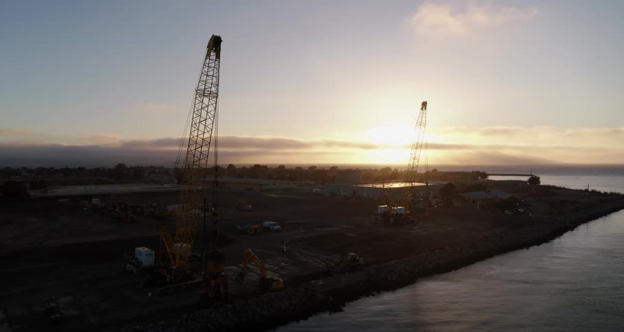 Construction machinery sits on the land next to the river
