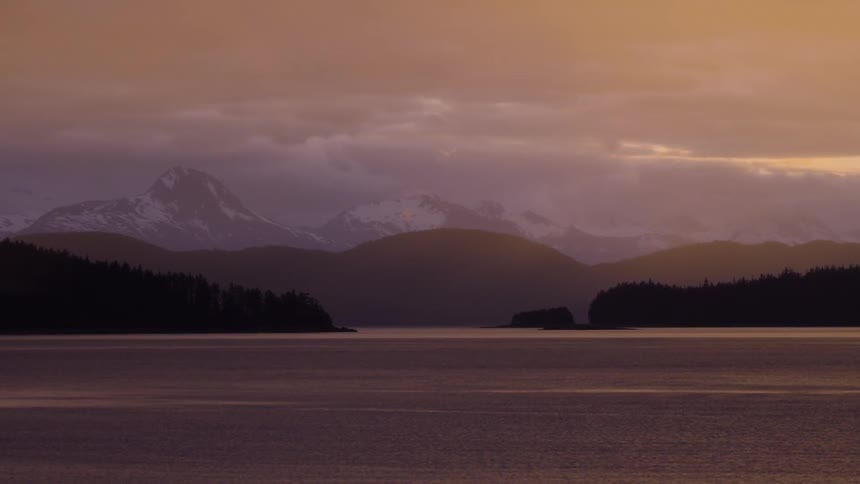 The sun sets over a mountain lake