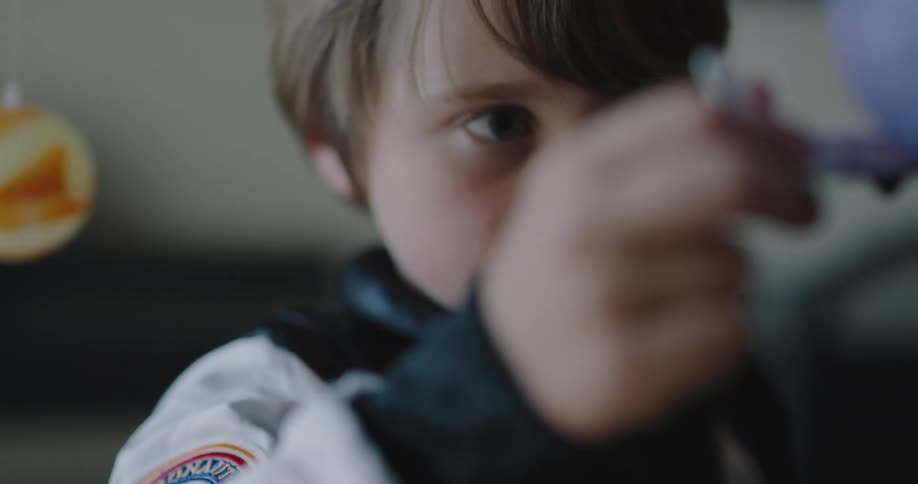 A boy with a toy spaceship pretending to be an astronaut