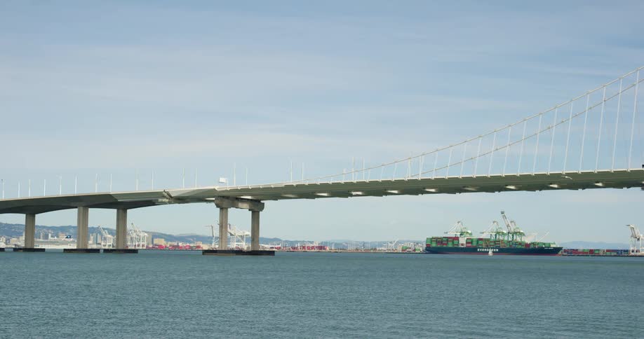 Bridge over the sea near the cargo ships docked in the pier