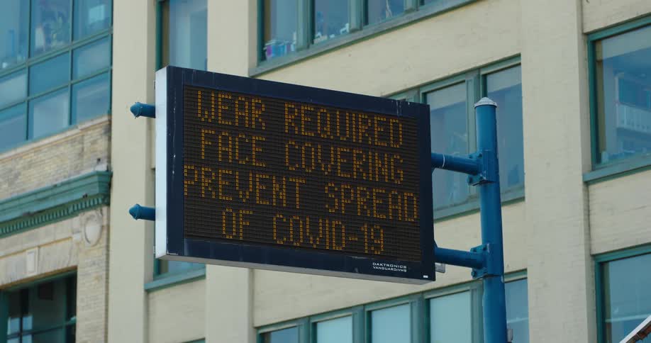 A sign posted on a pole near a building