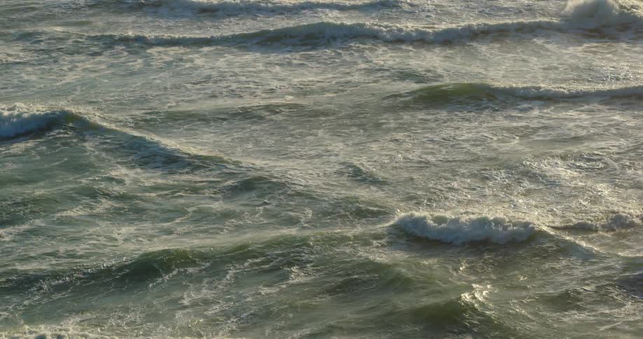 Waves rolling in the ocean during the day
