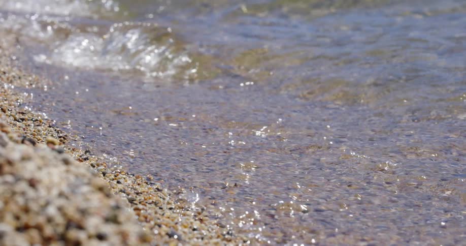 Small sea waves break against the coast