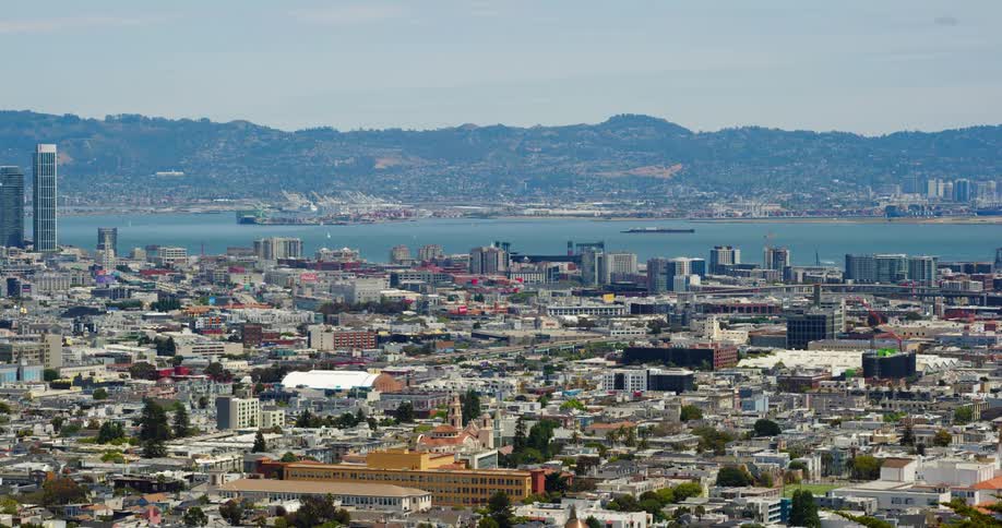 An expansive urban area is located at the edge of a body of water