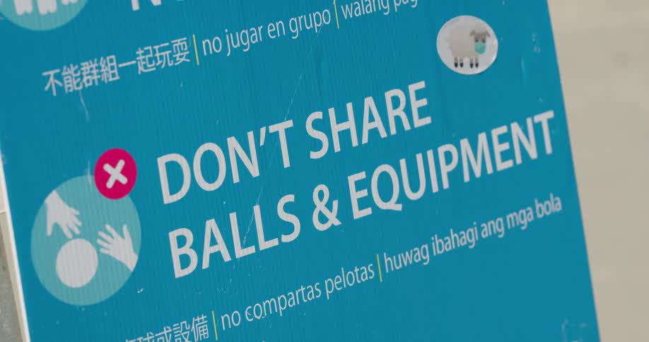 A blue and white sign with text relating to covid 19