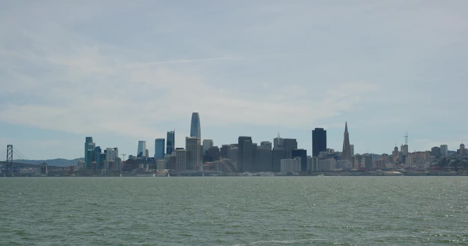 The skyscrapers of a metropolis loom over the ocean coastline