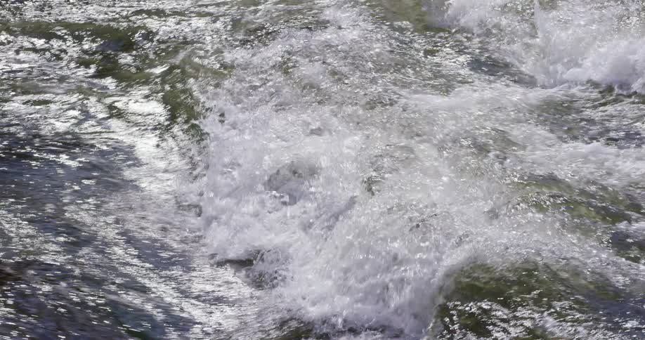 Water flowing over rapids on a river