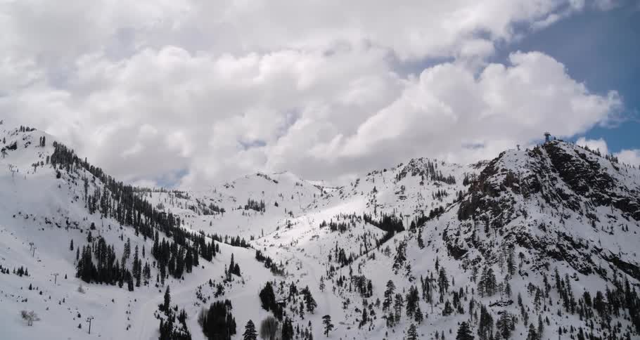 Aerial view of snow covered hills with trees
