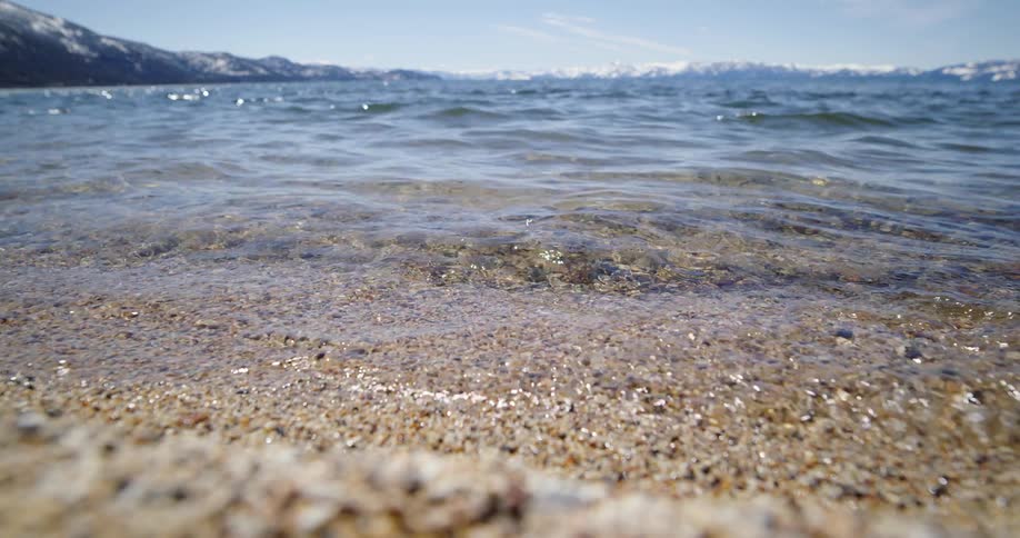 The water slowly moves over the sand